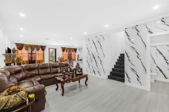 living room with ornamental molding and light hardwood / wood-style flooring