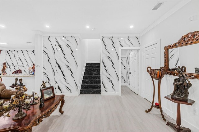 stairs featuring wood-type flooring and ornamental molding