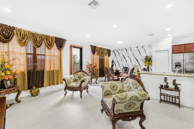 living area with crown molding