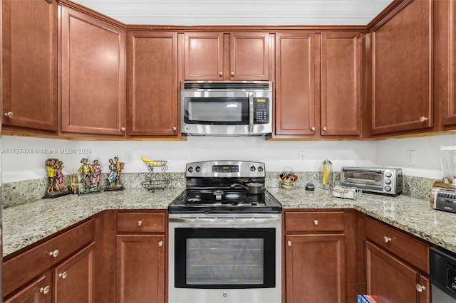 kitchen featuring crown molding, light stone counters, and stainless steel appliances