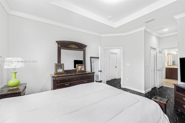 bedroom featuring crown molding and connected bathroom