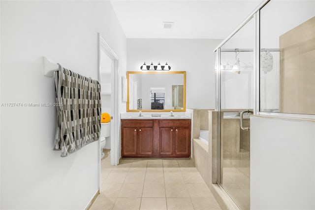 full bathroom with toilet, shower with separate bathtub, tile patterned floors, and vanity