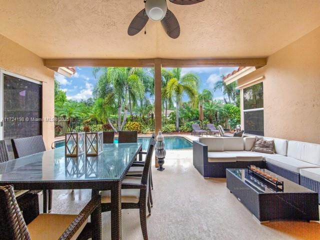 view of patio with ceiling fan and an outdoor living space