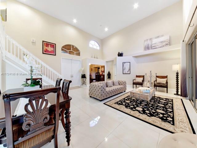 tiled living room with a high ceiling