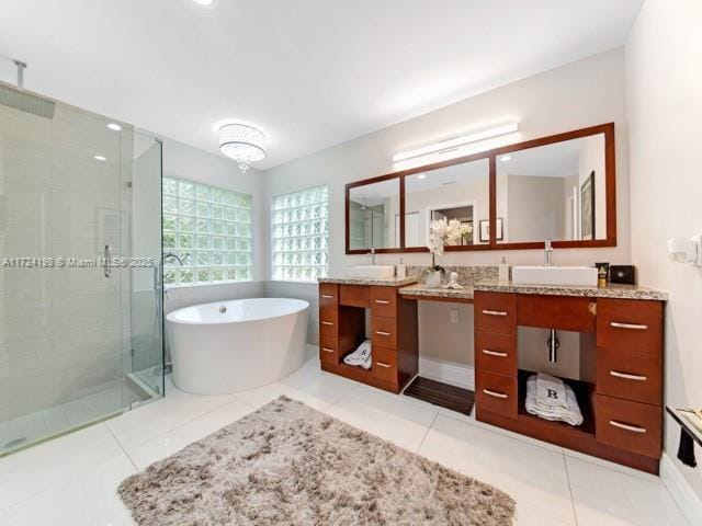 bathroom with plus walk in shower, tile patterned floors, and vanity