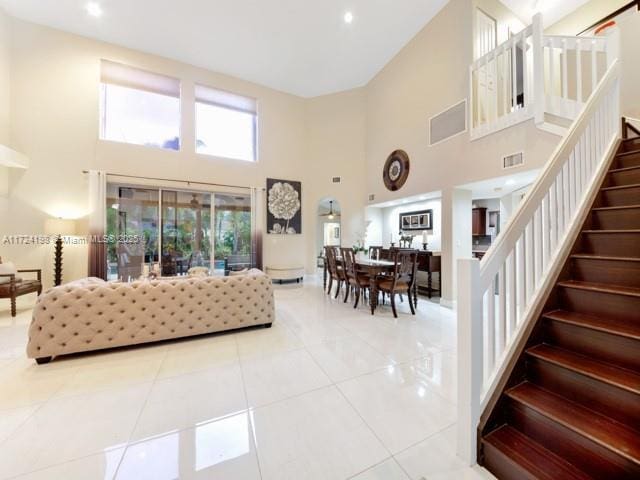 tiled living room with a high ceiling