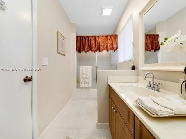 bathroom featuring an enclosed shower, vanity, and tile patterned floors