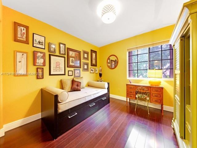 bedroom with dark wood-type flooring