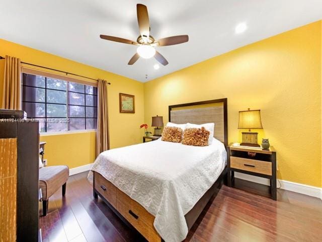 bedroom featuring ceiling fan and dark hardwood / wood-style floors