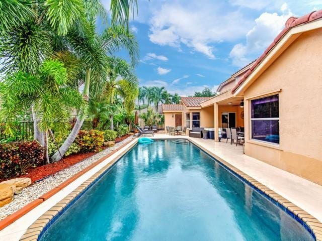 view of swimming pool featuring a patio area