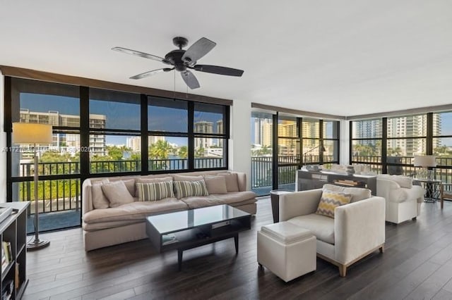 living room featuring ceiling fan, floor to ceiling windows, and dark hardwood / wood-style floors