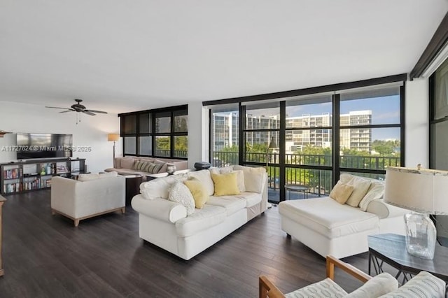 living room featuring ceiling fan, dark hardwood / wood-style flooring, and a wall of windows