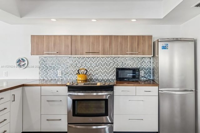 kitchen featuring white cabinetry, stainless steel appliances, and tasteful backsplash