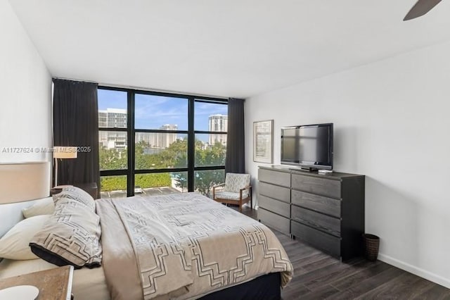 bedroom with ceiling fan, dark wood-type flooring, and expansive windows