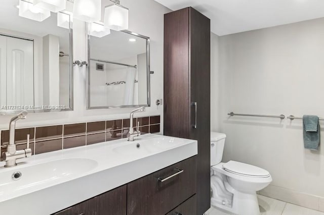 bathroom featuring toilet, vanity, tile patterned flooring, backsplash, and curtained shower