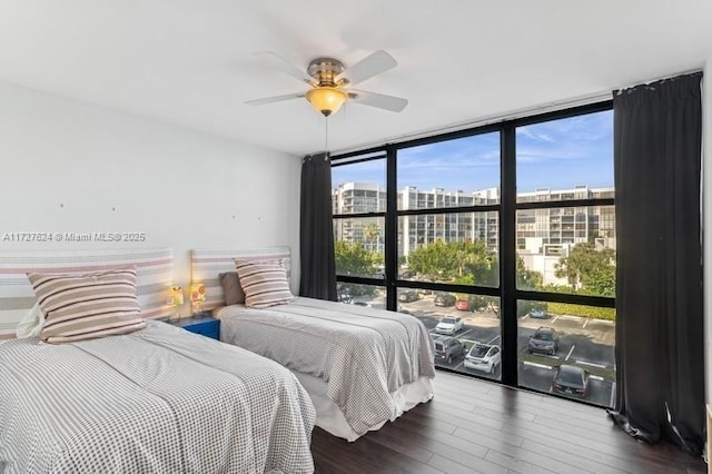 bedroom with ceiling fan, hardwood / wood-style flooring, and expansive windows