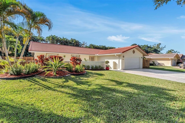 mediterranean / spanish home with a garage and a front lawn