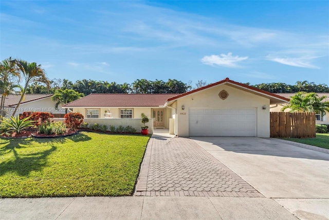 view of front of home with a garage and a front lawn