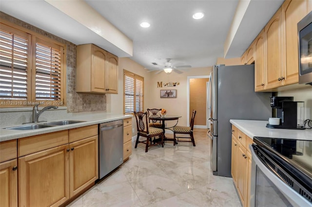 kitchen with light brown cabinetry, sink, a healthy amount of sunlight, and appliances with stainless steel finishes