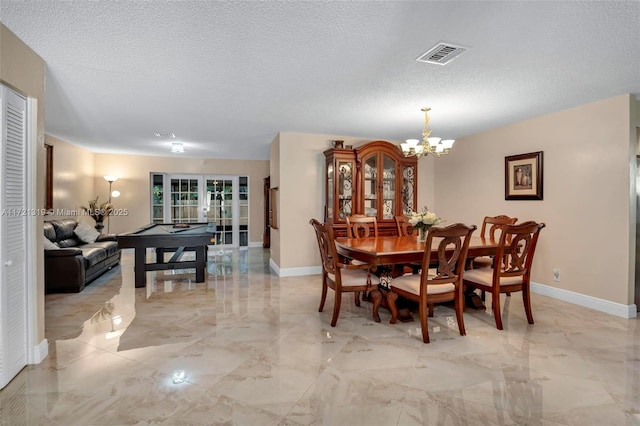 dining room featuring a chandelier, french doors, pool table, and a textured ceiling