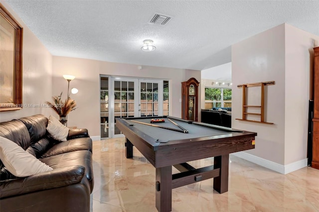 recreation room with french doors, pool table, and a textured ceiling