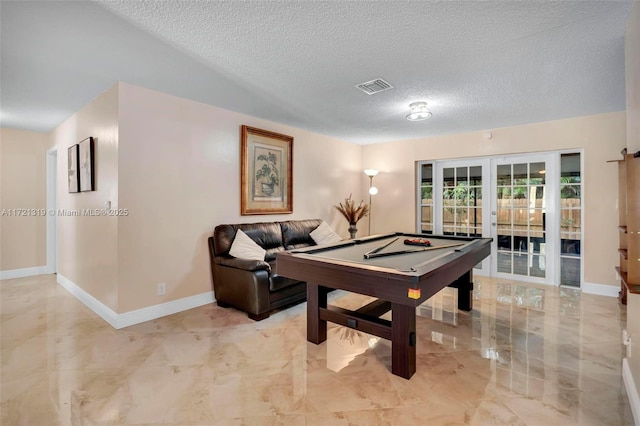 playroom featuring a textured ceiling, pool table, and french doors