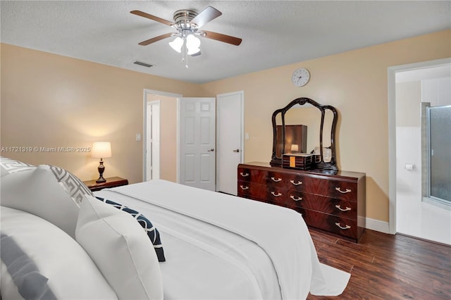 bedroom with a textured ceiling, ceiling fan, ensuite bathroom, and dark hardwood / wood-style floors