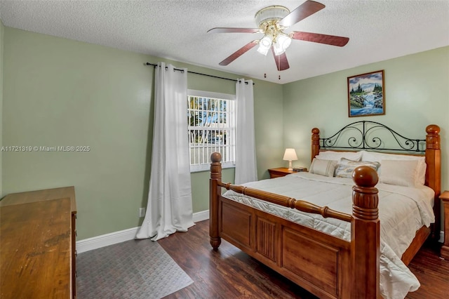 bedroom featuring ceiling fan, dark wood-type flooring, and a textured ceiling