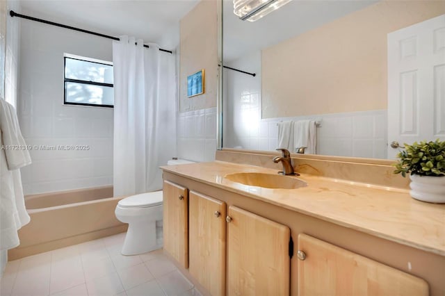 full bathroom with toilet, tile walls, tile patterned floors, shower / tub combo, and vanity