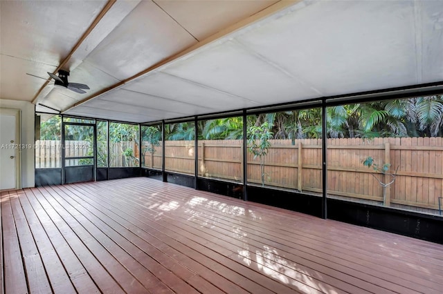 unfurnished sunroom with ceiling fan