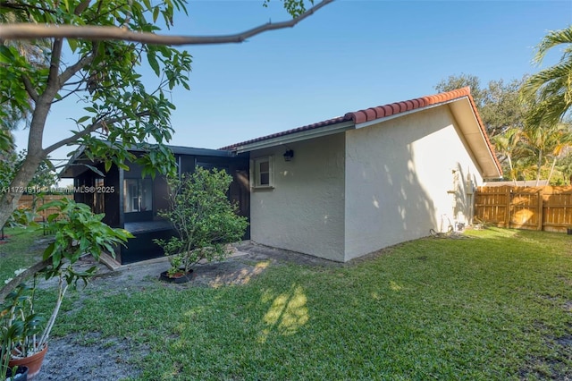 view of side of home with a yard