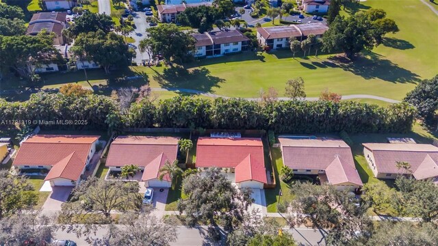 rear view of property with a lawn and a sunroom