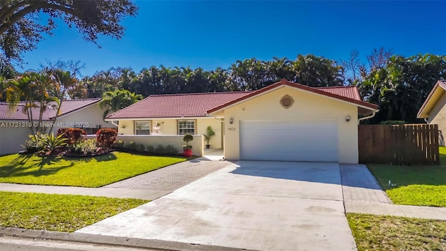 view of front of property with a garage and a front yard