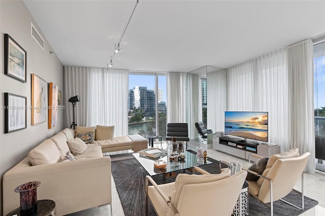 living room featuring track lighting and floor to ceiling windows