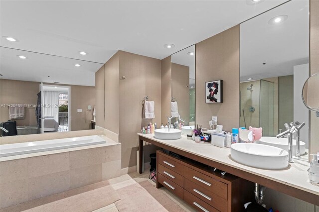 bathroom with vanity, plus walk in shower, and tile patterned flooring