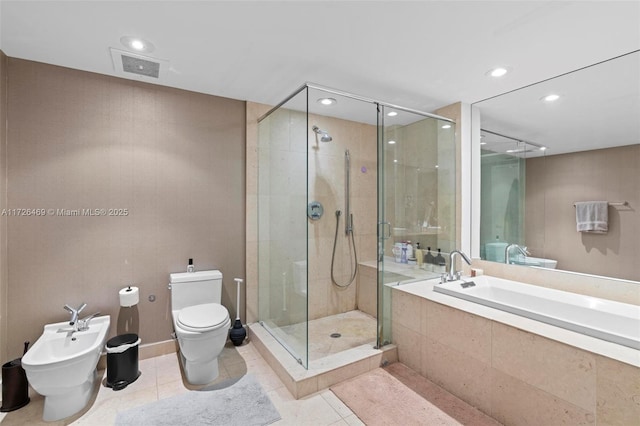 bathroom featuring a bidet, tile patterned floors, plus walk in shower, and toilet