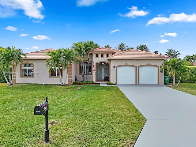 mediterranean / spanish home featuring a front yard and a garage