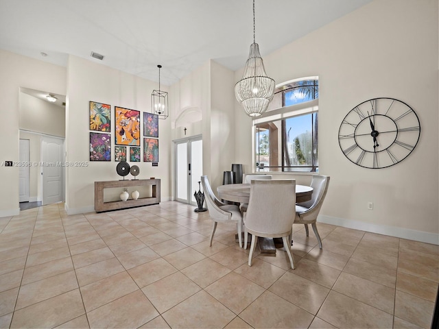 dining room featuring an inviting chandelier, light tile patterned flooring, and french doors