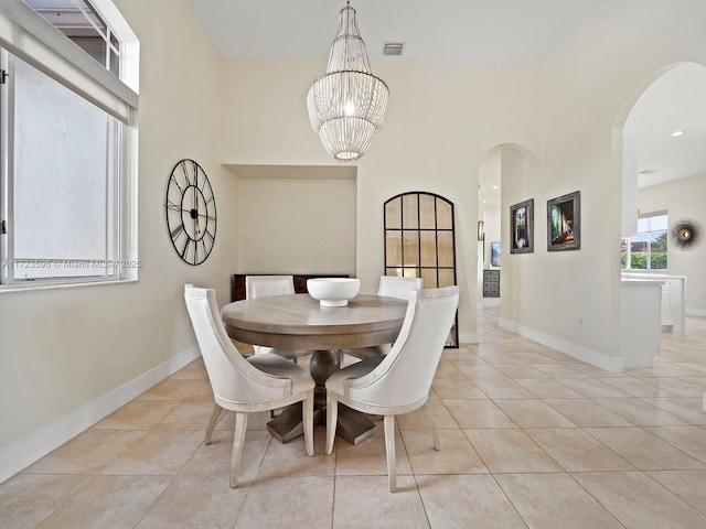 dining room featuring light tile patterned flooring and an inviting chandelier