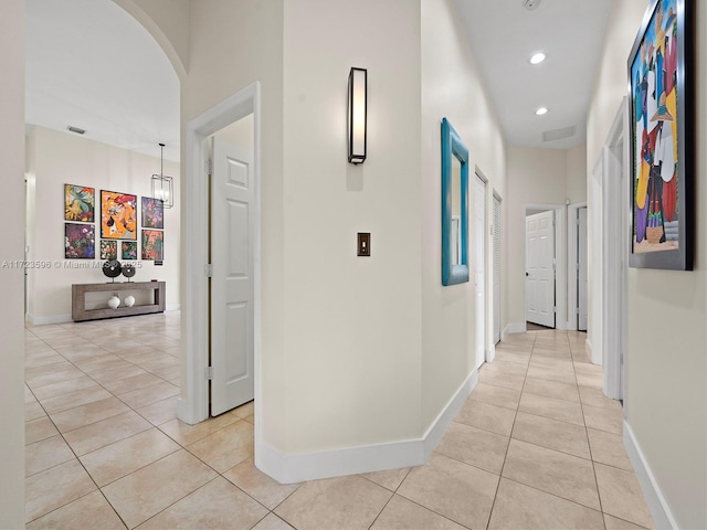 corridor featuring light tile patterned floors