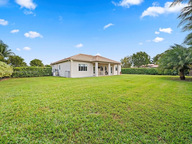 back of property featuring a yard