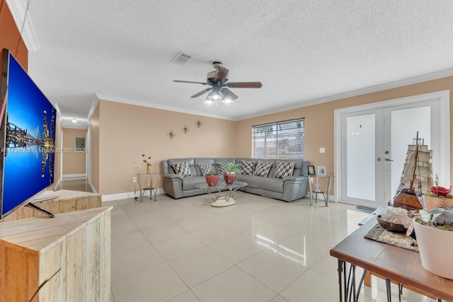 tiled living room with ceiling fan, french doors, ornamental molding, and a textured ceiling