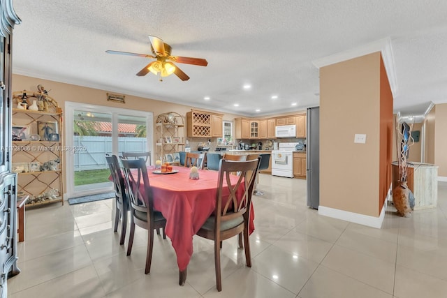 tiled dining room featuring ceiling fan, crown molding, and a textured ceiling