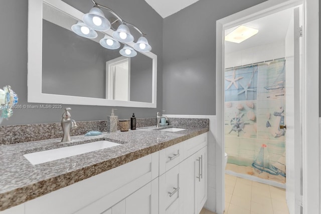 bathroom featuring tile patterned flooring, walk in shower, and vanity