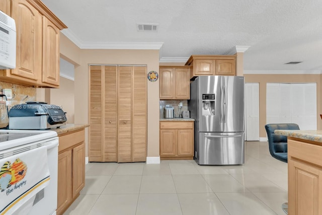 kitchen with backsplash, white appliances, light tile patterned flooring, and ornamental molding