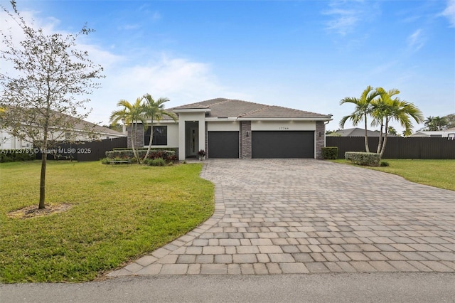 view of front of property with a garage and a front yard