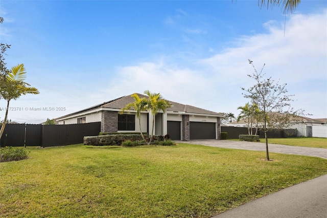 ranch-style home featuring a garage and a front lawn