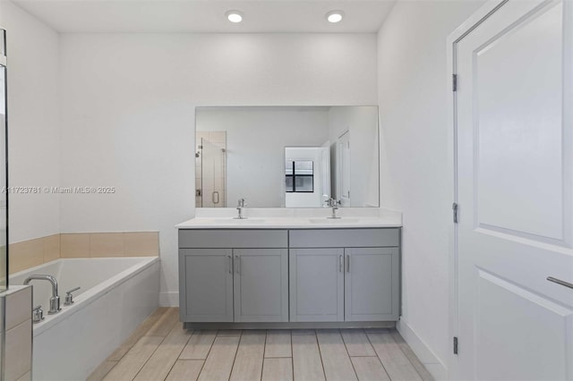 bathroom featuring vanity and shower with separate bathtub