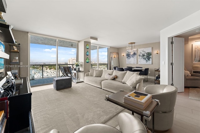 living room featuring floor to ceiling windows and a notable chandelier