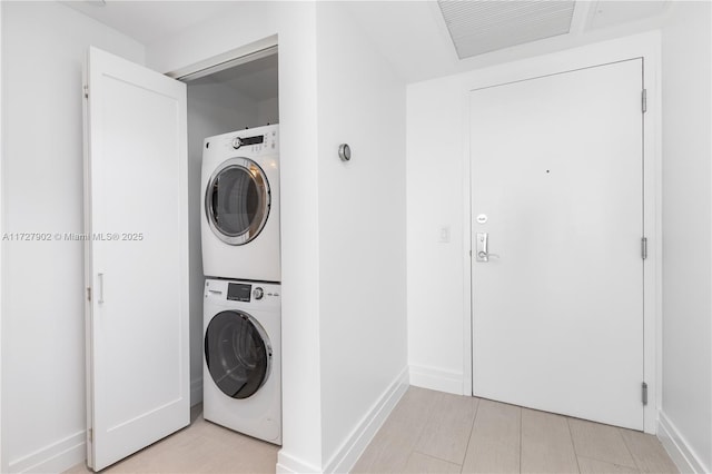 10 Venetian Way Unit 1903, Miami Beach, FL 33139 - laundry room featuring stacked washer and clothes dryer and baseboards